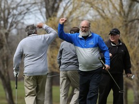 Players bump elbows at the end of their round at Rossmere Golf and Country Club on Watt Street in Winnipeg on Mon., May 4, 2020.