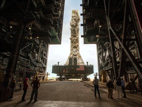 NASA employees look on as the Artemis launch tower rolls back from Pad 39B inside Bay 3 of the Vehicle Assembly Building (VAB) at the Kennedy Space Center in Cape Canaveral, Florida, U.S., on August 30, 2019.