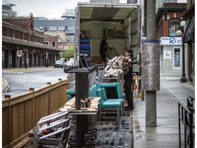 Jaylen McCausland, working with Tippet-Richardson, moves patio furniture out in front of Zak's Diner in the ByWard Market this week.