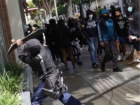 A man attempts to break the window of a store with a skateboard during widespread protests and unrest in response to the death of George Floyd on May 31, 2020 in Santa Monica, California. Protests continue in cities throughout the country after Floyd died in police custody in Minneapolis. The National Guard has been deployed in Los Angeles and other major US cities to attempt to stem the tide of rising violence and unrest, with President Donald Trump blaming ANTIFA and tweeting they will be designated a terrorist organization.
