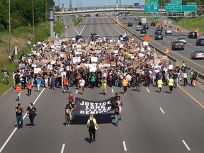 Demonstrators march in a protest against police brutality and the death of George Floyd on May 31, 2020 in St. Paul, Minnesota.