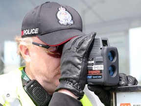FILE: An officer uses his radar gun in Ottawa.