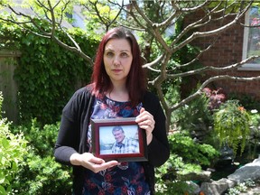 Joanne Hawdur holds a photo of her father, Martin Hawdur, who died of an aortic aneurysm on May 14.