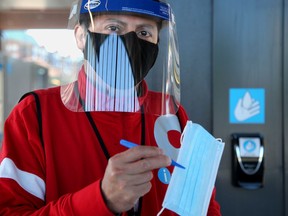 As masks became mandatory on OC Transpo Monday, all riders of the LRT train at Tunney's Pasture station seemed to be wearing their them. And for those that might have forgotten theirs, the OC Transpo's red vesters were handing out free ones to the public.