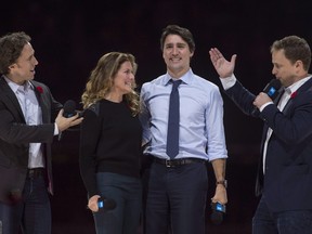 Co-founders Craig (left) and Marc Kielburger introduce Prime Minister Justin Trudeau and his wife Sophie Gregoire-Trudeau as they appear at the WE Day celebrations in Ottawa, Tuesday November 10, 2015.
