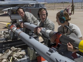 U.S. Air Force personnel prepare the AIM-9X Sidewinder missile for use during a live fire test at Holloman Air Force Base, New Mexico on April 23, 2019. (U.S. Air Force photo)