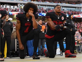 Colin Kaepernick, left, and Eric Reid kneel during the U.S. anthem before a San Francisco 49ers NFL game against the Arizona Cardinals on Oct. 6, 2016.