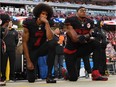 Colin Kaepernick, left, and Eric Reid kneel during the U.S. anthem before a San Francisco 49ers game against the Arizona Cardinals on Oct. 6, 2016.
