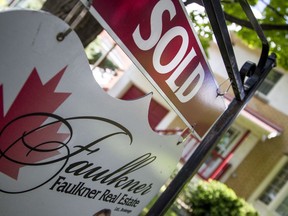 A Faulkner Real Estate "sold" sign stands in front of a Westboro home on Saturday.