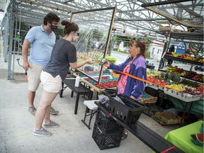 Kelley Grady served customers at the Parkdale Outdoor Market. The market is now open Thursday to Sunday from 9 a.m. to 5 p.m.