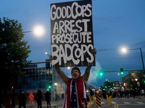 A demonstrator holds up a sign during a protest in Denver, Colorado, on May 31, 2020.