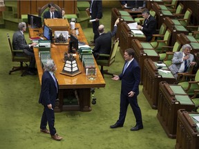 Government Leader in the House of Commons Pablo Rodriguez, left, and Conservative Leader Andrew Scheer confer from a safe distance before a meeting of the Special Committee on the COVID-19 Pandemic recently.
