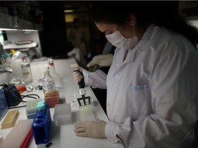 A researcher works on one of the many global projects to find a vaccine for the coronavirus disease (COVID-19).