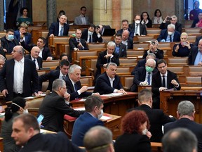 Hungarian Prime Minister Viktor Orban (seated, middle of photo), votes on the law granting the government special powers to combat the coronavirus disease (COVID-19) crisis, in the Hungarian parliament in Budapest, March 30.