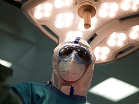 FILE PHOTO: Doctor Islam Muradov performs emergency surgery in the operating room of the City Clinical Hospital Number 15 named after O. Filatov, which delivers treatment to patients infected with the coronavirus disease (COVID-19), in Moscow, Russia.