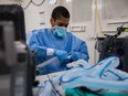 U.S. Army Specialist Fredrick Spencer assembles a T1 Hamilton ventilator in a mobile lab unit in New York City.