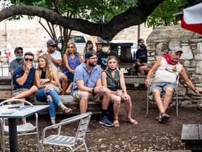 People sit at an outdoor bar and eating area in Austin, Texas, U.S., June 28, 2020.