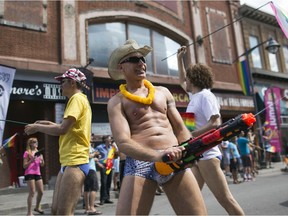 Revellers take part in the Ottawa Pride Parade on Bank Street, August, 24, 2014.
