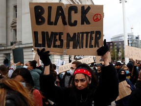 A woman holds a sign during a Black Lives Matter protest in Centenary Square in Birmingham, following the death of George Floyd.