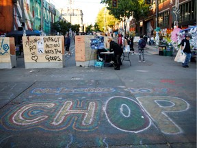 Street art, modified to represent the area's acronym change from CHAZ to CHOP, is seen as protesters against racial inequality occupy space at the CHOP area near the Seattle Police Department's East Precinct in Seattle, Washington, U.S. June 16, 2020.