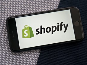 The Shopify logo on a smartphone.