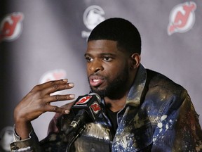 In this July 25, 2019, file photo, New Jersey Devils' NHL hockey defenseman P.K. Subban speaks after he was introduced to the media at the Prudential Center in Newark, N.J. Subban and the NHL are bringing something new to television Saturday for fans and everyone dealing with the isolation and hardships caused by the coronavirus pandemic. It's NHL Hat Trick Trivia. Subban is the host of the weekly 30-minute show in which contestants will answer up to three hockey trivia questions for prizes, the top one being two tickets to any game next season.