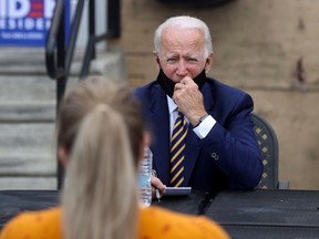 Democratic U.S. presidential candidate Joe Biden talks with members of the public about the effects of COVID-19 on their small businesses in Yeadon, Pennsylvania recently.