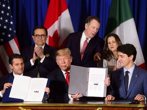 Prime Minister Justin Trudeau, right to left, Foreign Affairs Minister Chrystia Freeland, United States Trade Representative Robert Lighthizer, President of the United States Donald Trump, Mexico's Secretary of Economy Ildefonso Guajardo Villarreal, and President of Mexico Enrique Pena Nieto participate in a signing ceremony for the new United States-Mexico-Canada Agreement in Buenos Aires, Argentina, Friday, Nov. 30, 2018.
