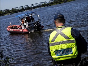 Police search on Saturday for a 14-year-old boy who went missing Friday after jumping from the Prince of Wales Bridge in background. The victim's body was recovered Monday.