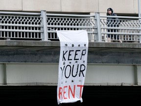 A 'Keep Your Rent' banner hangs from the Laurier Avenue Bridge during the COVID-19 pandemic earlier this spring.