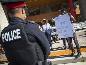 Ottawa Police Chief Peter Sloly listens as a list of demands is read out in front of City Hall last month.