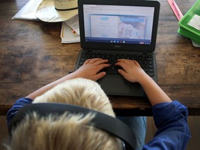 A young student does his school work remotely during the pandemic.