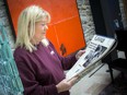 Alana Kainz looks at a scrapbook compiled for her following the death of her husband, Brian Smith, in 1995.