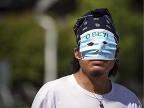 A group gathered at city hall to participate in the March To Unmask in Ottawa on Sunday, July 19, 2020.