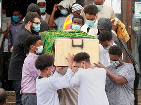 Hundreds attended the funeral for homicide victim Mohamed Hassan, seen here being carried out of the Ottawa Mosque on Northwestern Avenue on Thursday.