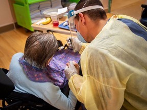 A Canadian soldier helps a senior citizen with her meal at a long-term care facility back in May. Families have, for the most part, been shut out of such facilities during the pandemic when in fact they would be a huge help to their frail relatives.