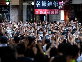 TOPSHOT - Protesters chant slogans and gesture during a rally against a new national security law in Hong Kong on July 1, 2020, on the 23rd anniversary of the city's handover from Britain to China. - Hong Kong police arrested more than 300 people on July 1 -- including nine under China's new national security law -- as thousands defied a ban on protests on the anniversary of the city's handover to China.