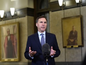 Minister of Finance Bill Morneau participates in a remote TV interview in the Foyer of the House of Commons after presenting a fiscal snapshot of the economic impact of the COVID-19 pandemic.