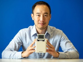 FILE: Spartan Bioscience Inc. CEO Paul Lem holds one of his company's COVID-19 portable, rapid testing devices in a handout photo.
