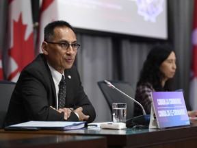 Canada's deputy public health chief Dr. Howard Njoo speaks as Chief Public Health Officer of Canada Dr. Theresa Tam listens during a news conference on the COVID-19 pandemic on Parliament Hill in Ottawa, on Monday, June 29, 2020. Canada's deputy public health chief says going inside a bar to have a drink with friends remains a high risk activity in the era of COVID-19.