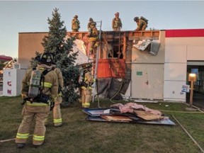 Ottawa Fire Services firefighters bring a fire at a Petro Canada service station on Innes Road under control on Tuesday evening.
