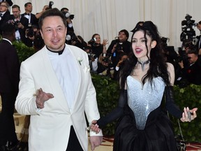 In this file photo taken on May 7, 2018 Elon Musk and Grimes arrive for the 2018 Met Gala, at the Metropolitan Museum of Art in New York.