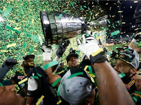 Edmonton Eskimos players raise the Grey Cup after they defeated the Ottawa Redblacks in the CFL's 103rd Grey Cup championship football game in Winnipeg, Manitoba, Nov. 29, 2015.
