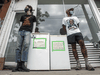 Julian Bentivegna, left, and Jalil Bokhari with a couple community fridges in front of Ten Restaurant on College Street in Toronto.