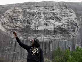 FILE PHOTO: A woman speaks in front of the monument after protesters marched against the Confederate Monument carved into granite at Stone Mountain Park in Stone Mountain, Georgia, U.S. June 16, 2020.