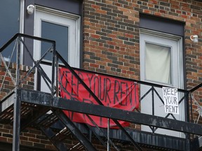 Signs calling for a rent strike hang from an apartment balcony during the coronavirus disease (COVID-19) restrictions in Toronto, Ontario, Canada April 18, 2020.