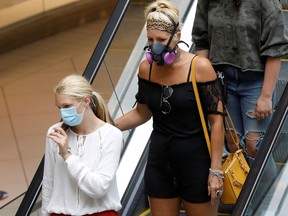 People walk through the Rideau Centre, as efforts continue to help slow the spread of the coronavirus disease (COVID-19), in Ottawa, Ontario, Canada July 13, 2020.