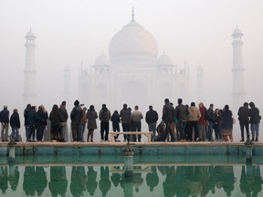 Visitors pictured at Taj Mahal in January 2019 view the monument through morning air pollution.