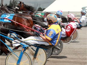 Driver Robbie Robinson (yellow and blue) takes the inside corner during a qualifier at the Rideau Carleton Raceway.