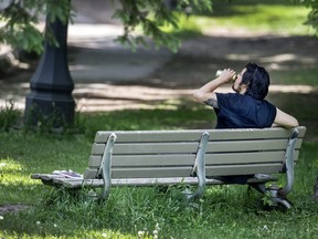 A person enjoys a beverage in Toronto's Trinity Bellwoods Park during the Covid-19 pandemic, Thursday June 4, 2020.